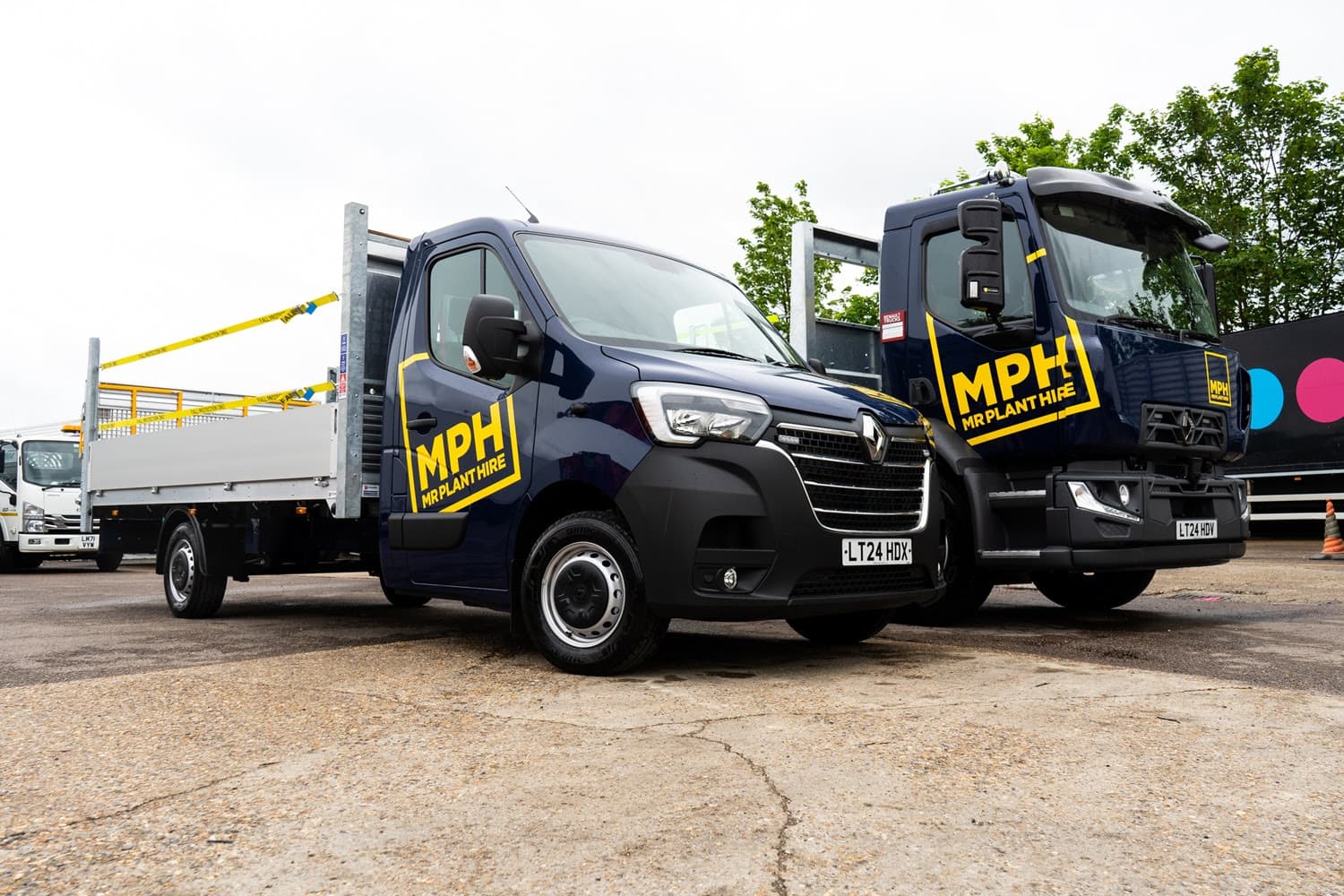Two Mr Plant Hire branded vehicles parked at a depot